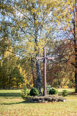 Brown wooden cross with crucifix in churchyard