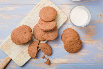 Pile of Delicious Chocolate Chip Cookies on a  board with Milk Bottles