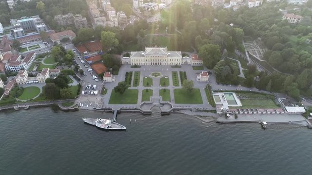 Helicopter aerial view of Villa Olmo is neoclassical building located in city of Como northern Italy and is open to public during exhibitions while lakeside gardens are accessible during daytime 4k