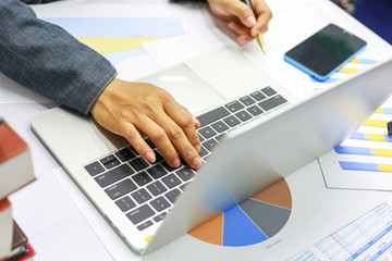 hand businesswomen are typing on computers to find current online trading trends.