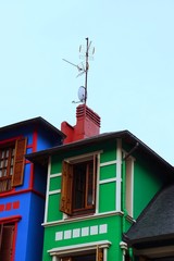 window on the green facade of the house in Bilbao city Spain