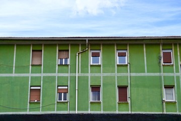 window on the green facade of the house in Bilbao city Spain