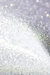 Silver defocused glitter backround with place for text.