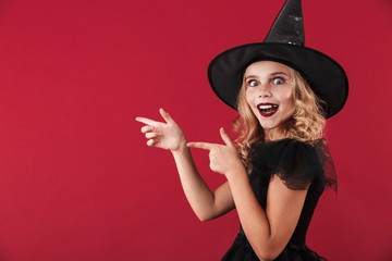 Happy little girl witch in carnival halloween costume
