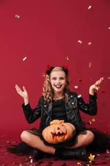 Obraz na płótnie Canvas Little girl devil in carnival halloween costume