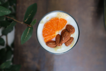 mango smoothie or yogurt with orange and almond topping