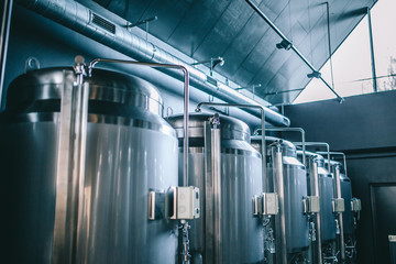 Craft beer brewing equipment in brewery! Metal tanks, alcoholic drink production