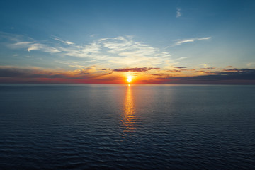 Evening by the sea, beautiful sunset over Baltic seashore, close up view on small waves