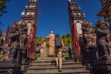 Young man tourist in budhist temple Brahma Vihara Arama Banjar Bali, Indonesia