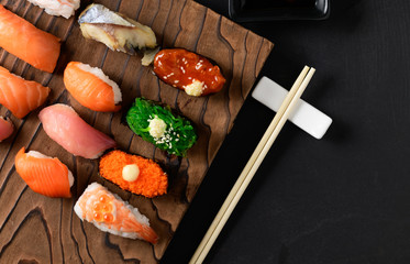 close up of sashimi sushi set with chopsticks