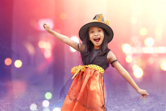 Asian child girl with witch costume standing