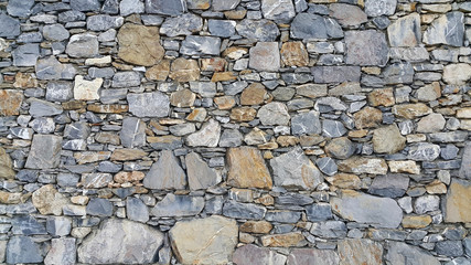 Old wall from stones of various shapes