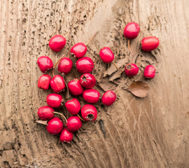 Red hawthorn berries on a wooden background