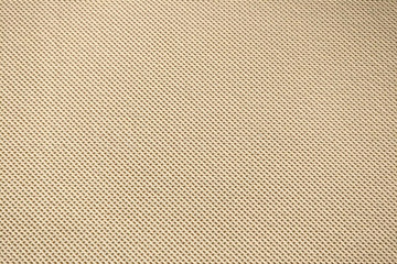 The background is yellow fabric with a repeated uniform pattern of dots