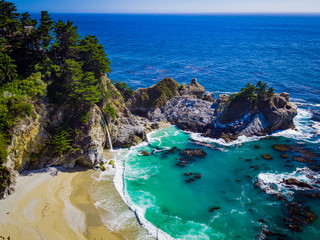 Aerial view of Water Fall McWay Falls Julia Pfeiffer Burns Park Big Sur California. McWay Falls a waterfall empties directly into the ocean. - obrazy, fototapety, plakaty