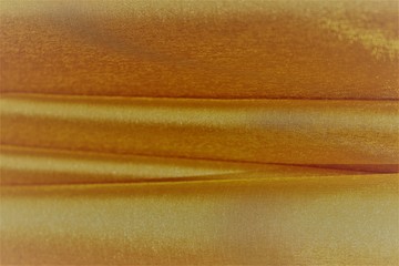 Brown-gold fabric background. Warm shade.Silk, satin, organza.