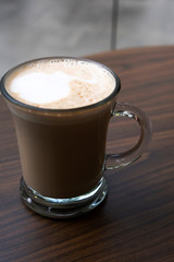 Hot coffee on a wooden table