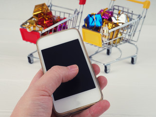 a cart full with gifts, the conception of Christmas gifts and shopping, the concept of online shopping