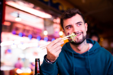 tow young couple asiatic and European eating in japanese restaurant
