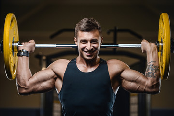 Fototapeta premium Handsome strong athletic men pumping up muscles workout fitness and bodybuilding concept background - muscular bodybuilder fitness men doing arms abs back exercises in gym naked torso.