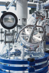Fototapeta premium The upper part of the chemical reactor. The glass reactor lid is equipped with piping.