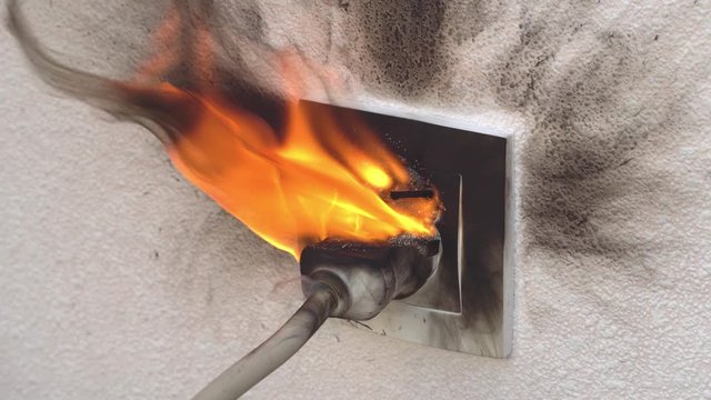 burning socket from short circuit in house. concept of fire in apartment.