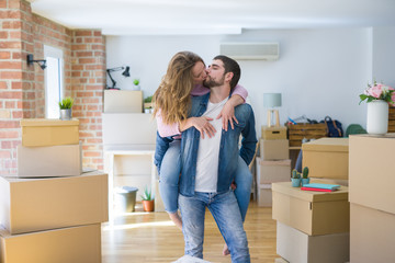 Young couple moving to a new house, boyfriend giving a piggy back ride to girlfriend, very happy and cheerful for new apartment