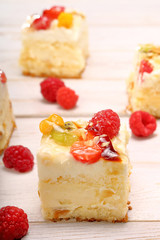 Creamy cake with fruit on wooden background and empty space for text