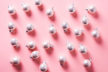 Christmas background with silver balls on pink. Top view. Xmas pattern. New Year.