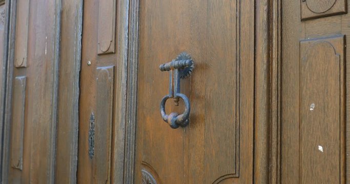 Old medieval door knocker on wooden old heritage door in Loire valley, Le lude, France 27/2/19