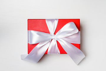Red box with a gift on a white background
