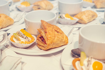 Blurred for Background.Glass of white coffee with the bread between the brake and the brake food background.