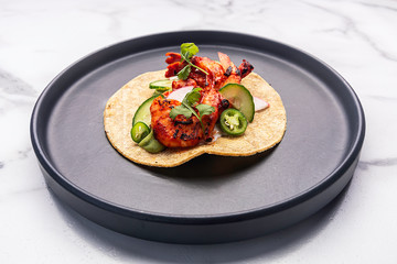 Delicious dish with a shrimp taco, with chili, coriander, onion and cheese