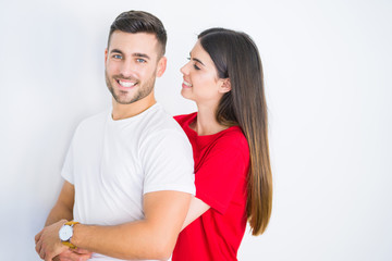 Young beautiful couple in love hugging over white isolated background