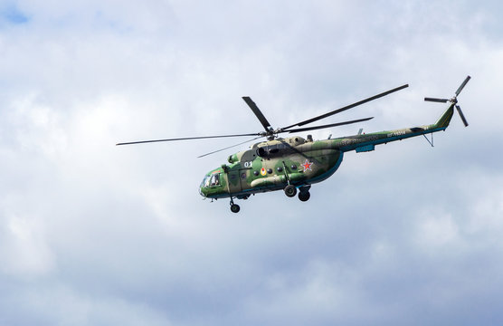 Russian Air Force Mi-8 helicopter in camouflage flying against cloudy sky