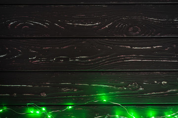 Garland with green light elements in the dark close up