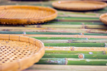 Obraz premium handmade thai basket on bamboo poles