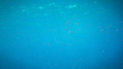 micro plastic pollution, nurdles and plastic particle in ocean water