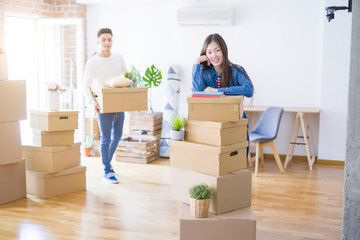 Beautiful young asian couple looking happy, young woman smiling excited moving to a new home