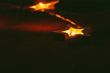 Fototapeta premium Beautiful bokeh light of star shaped garland in the dark