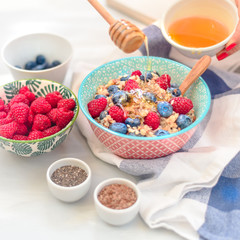 breakfast buckwheat porridge with raspberries and blueberries, good morning concept