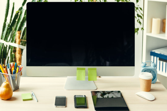 Office  or home workspace. Computer monitor with black screen on office table with supplies