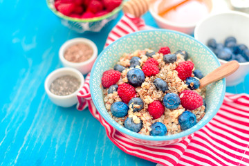 breakfast buckwheat porridge with raspberries and blueberries, good morning concept
