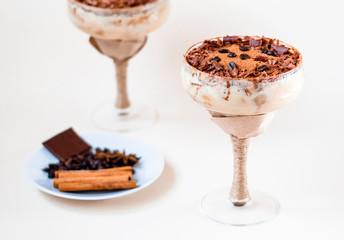 italian dessert tiramisu in an elegant cocktail glass, the concept of sweet life, luxury, delicious food
