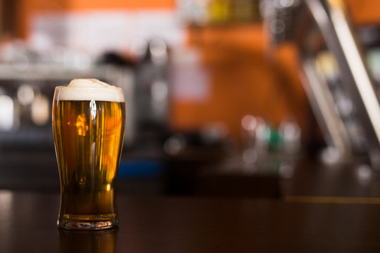 Image of light Beer in a traditional pint glass on table