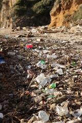 Plastic waste deposited from the sea on the beach after the storm. Liguria, Italy.