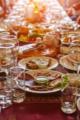 A blurred dining room for an Asian audience sits in a long line of table.