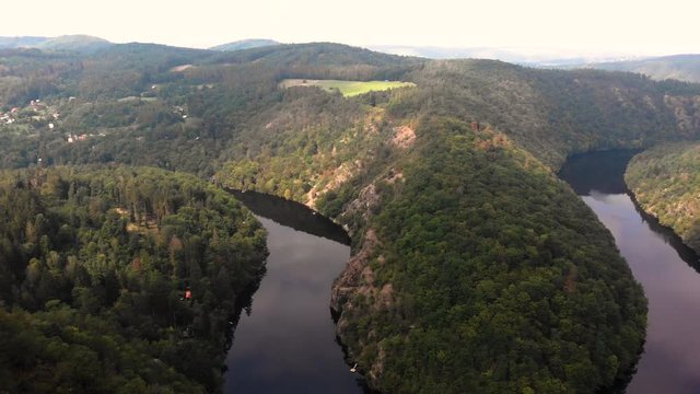 Aerial reveal view of incredible Vyhl&iacute;dka M&aacute;j. Calm, relaxing, horseshoe river meander. 
