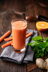 Immunity boosting drink for breakfast, freshly made nutritious carrot, orange and ginger juice
