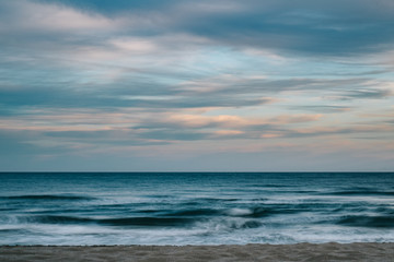 Fototapeta premium Long exposure photography of the sea with clouds at sunset